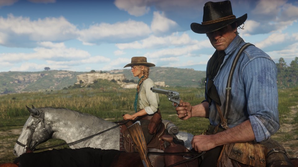 Dos jinetes montan caballos de distinto pelaje en campo abierto en Red Dead Redemption 2
