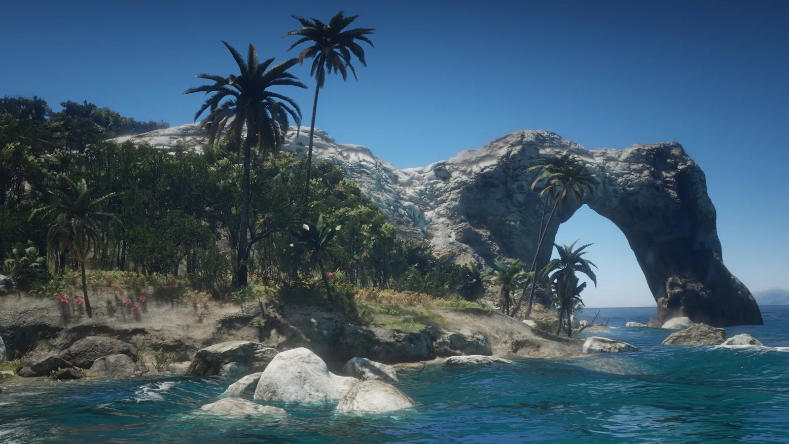 Costa de Guarma con palmeras y un arco de roca sobre el mar en Red Dead Redemption 2