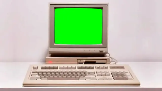 Old beige computer with a CRT monitor, green screen and keyboard
